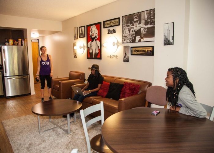 three female students sitting in their living room